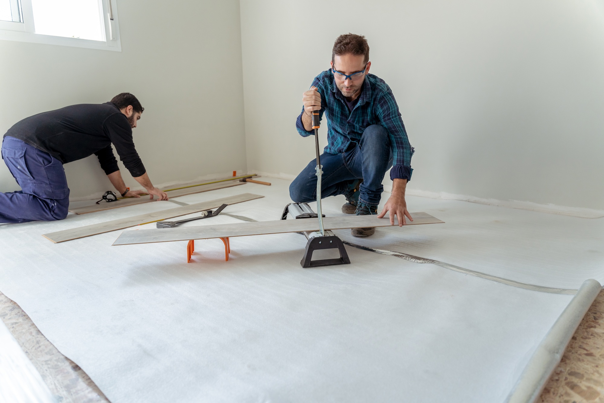 general shot of two men working on the installation of a laminate wood floor